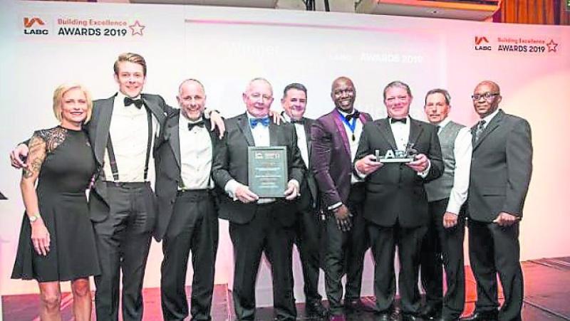 The JM Construction Ltd team accepting their prestigious Building Industry Award recently