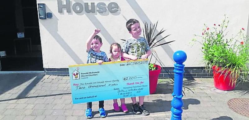Grace and her siblings get ready to present a cheque to Ronald McDonald House