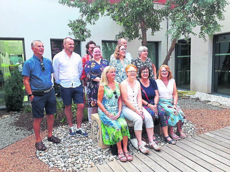 Adult group relaxing on the bench presented to Essert Council by Longford County Council during the 22nd twinning exchange between Ballinamuck and Essert in France