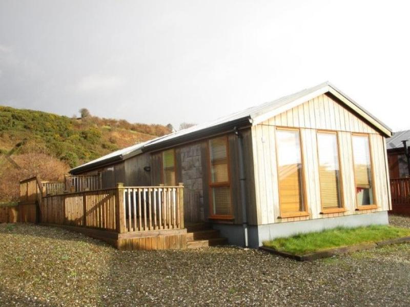 WATCH: This affordable shoreside log cabin is a refreshing spin on the usual holiday park home