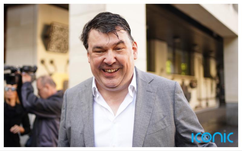 Father Ted creator arrives at court for trial of alleged harassment of trans activist