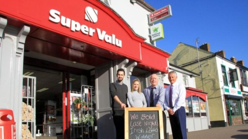 Pat Smyth of Smyth's SuperValu in Ballymahon (right) with staff members Fergal O'Toole, Edel Lyons, and Larry Cooney, pictured outside the supermarket after learning it had sold the winning Lotto tick