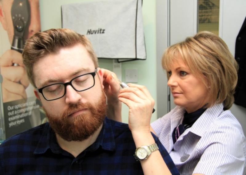 Longford Leader reporter Patrick Conboy becomes 'deaf for a day' with the help of audiologist Lynn Morris at SpecSavers in Longford. Photo: Michelle Ghee. www.gphotos.ie