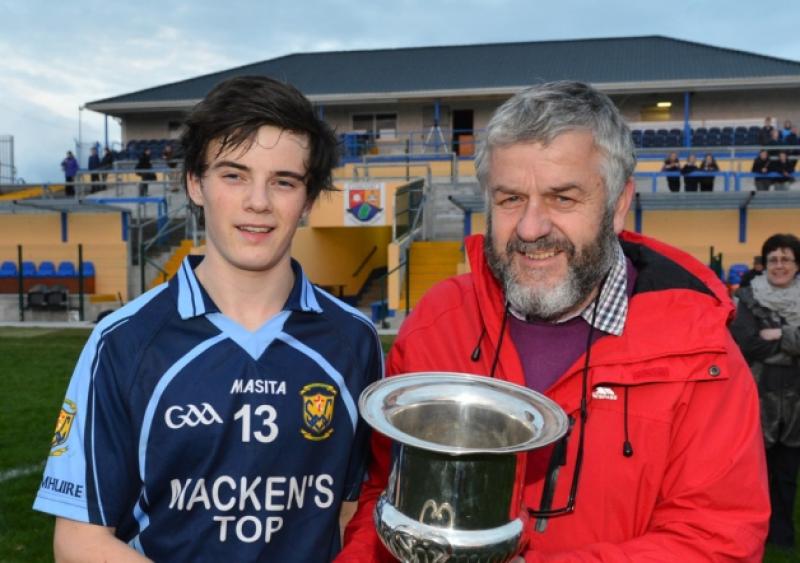 Chairman of the Longford Post-Primary Schools Committee, Albert Fallon presenting the Fr McGee Cup to Cnoc Mhuire Granard captain, Rian Brady. Photo: Ray Donlon