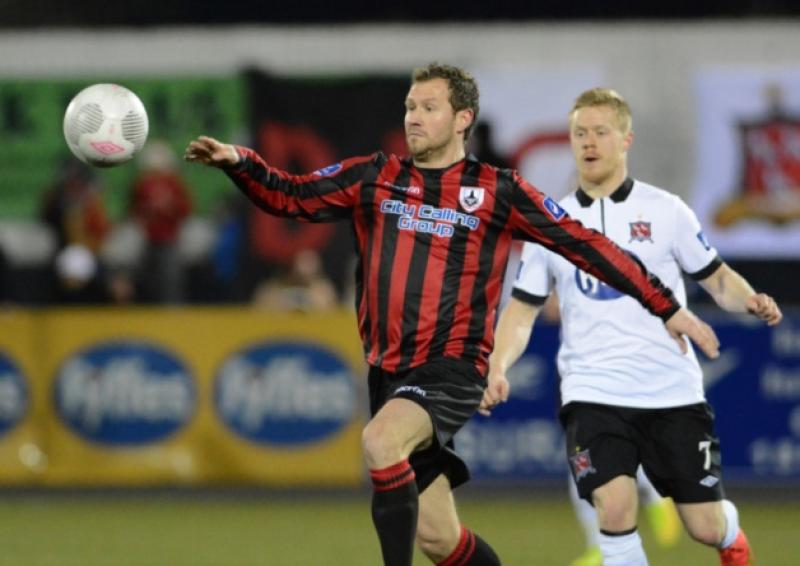 Longford Town defender Pat Sullivan clearing the danger ahead of Dundalk opponent Daryl Horgan. Photo: Ciaran Culligan