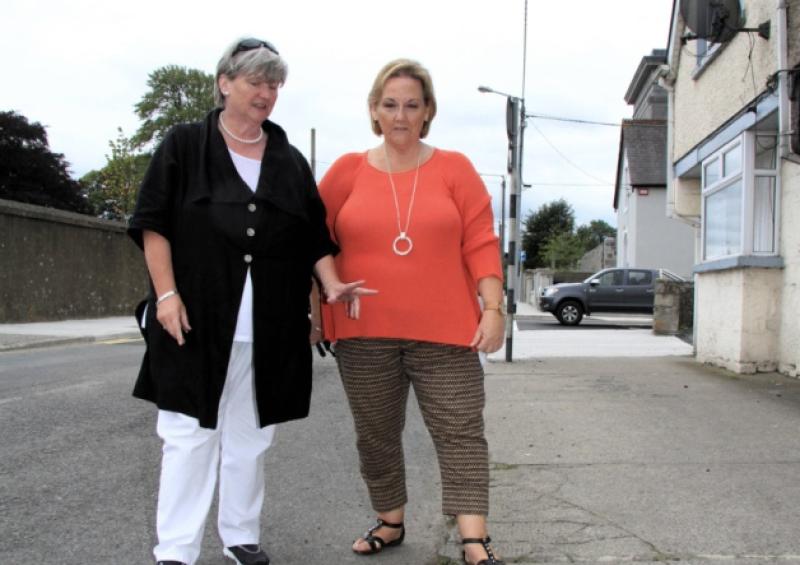 Cllr Mae Sexton (Independent) and Cllr Peggy Nolan (Fine Gael) pictured at a damaged footpath on St Mels Road. Photo: Michelle Ghee. www.gphotos.ie