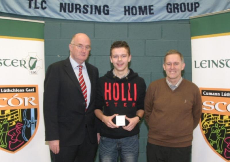 John Horan, Leinster Council GAA Chairperson (left) and Aidan Walsh, Chairperson of Leinster Sc�r (right), pictured with Leinster Sc�r na nOg Solo Singing winner Nathan Brady from Colmcille, Co Longford, at last Saturday's Leinster Finals in St Brigid's GAA Club, Dublin. Photo: molloyphotography