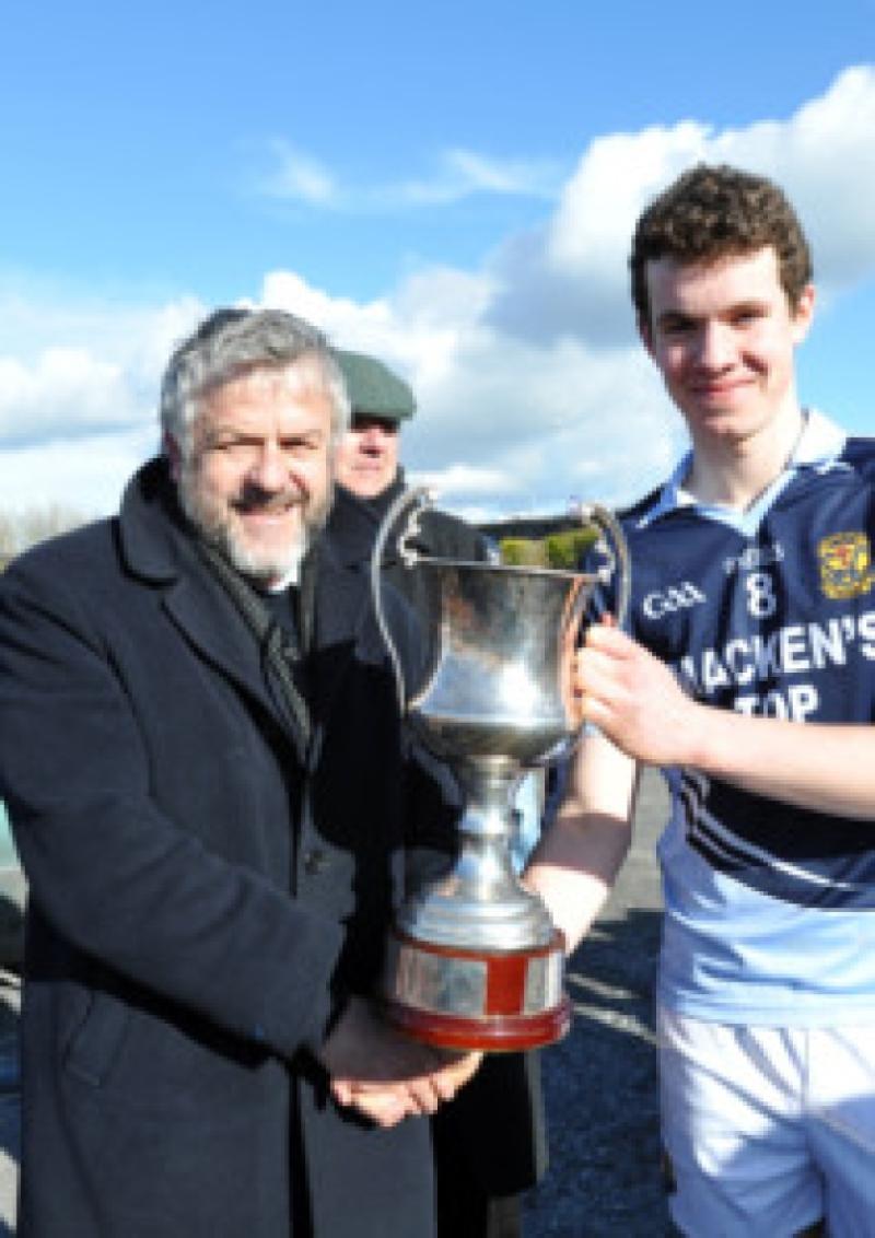 Albert Fallon presents Cnoc Mhuire Granard captain David McGivney the Leinster Vocational Schools Senior A Football Championship Cup after their victory on Saturday last at the St. Loman's grounds Mullingar.