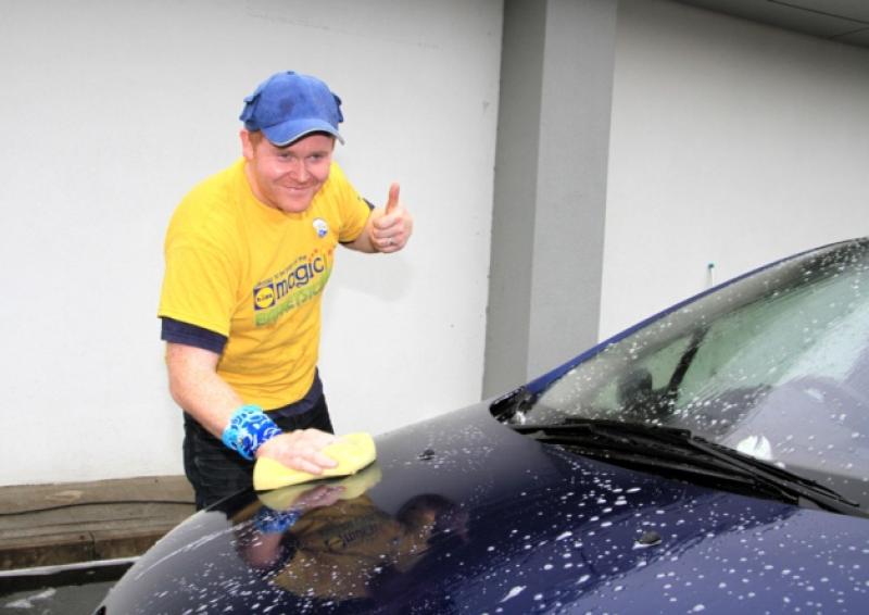 Shane Mulligan washing a car to raise funds for Barretstown. Photo: Michelle Ghee www.gphotos.ie