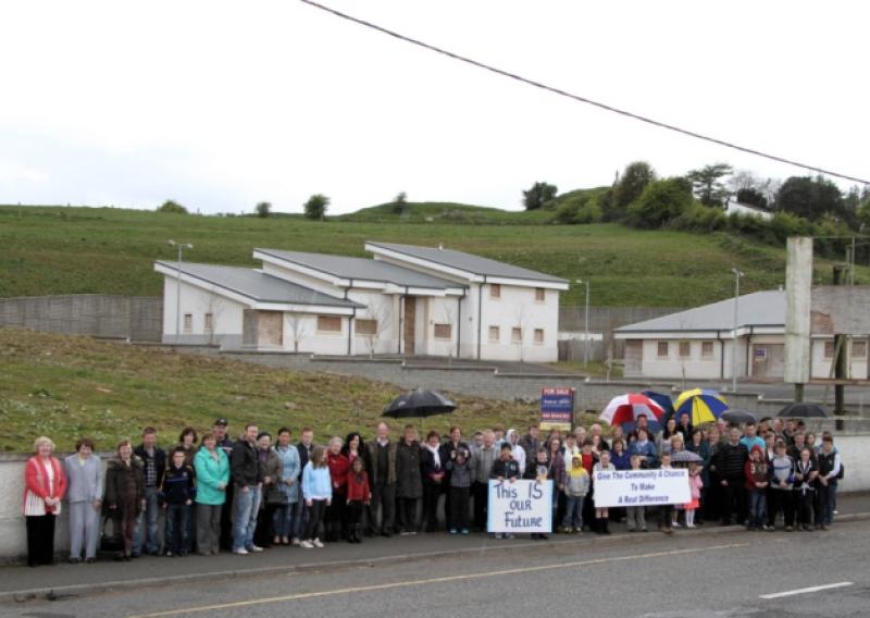 Local residents stand outside the entrance to the proposed site of the new visitors' centre in Granard town. Photo: Michelle Ghee. www.gphotos.ie