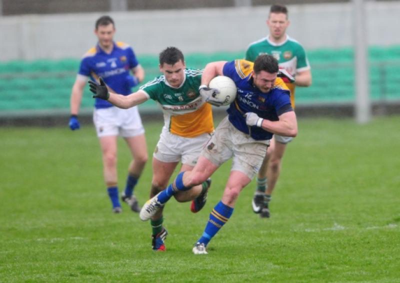 Longford's Michael Quinn evades the challenge of Offaly's Eoin Carroll. Photo by Kevin Leavy