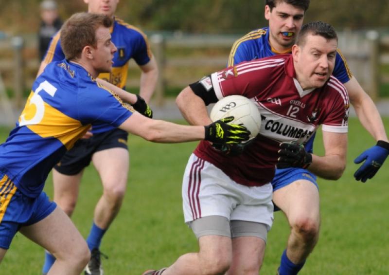 Mullinalaghta player Thomas McCabe has the ball in his grasp in this tussle with Dromard opponent Enda Kiernan. Photo: Declan Gilmore Photography