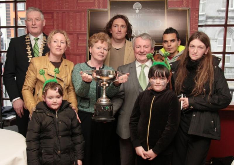 Longford Chamber of Commerce President Fintan McGill and Seamus Butler pictured with the overall winning entrants in the Longford parade, St Joseph's NS. Photo: Shelley Corcoran