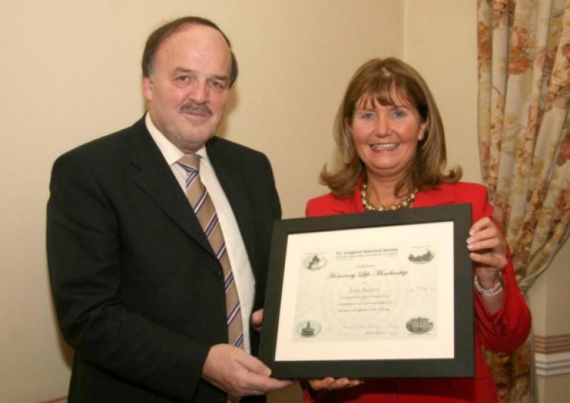 Luke Baxter, author of 'Our Roots in Stone' Memorial Records - Ardagh, Co. Longford 1646-1910; pictured receiving his 'Honorary Lifetime Membership' of Co Longford Historical Society from Mary Carlton-Reynolds.