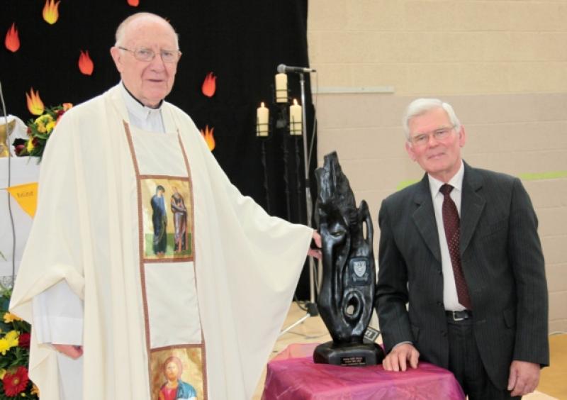 Bishop Colm O'Reilly receiving a presentation from from Michael Denning, Board of Management chairman at Moyne Community School. Photo: Shelley Corcoran