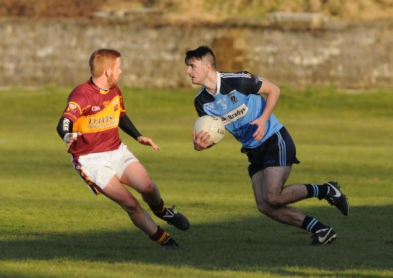 Tadhg Maher on the ball for Longford Slashers in his attempt to evade the challenge of Fr Manning Gaels opponent Mickey Kelly. Action from the Division 1 league game at Fay Park on Saturday evening last.  Photo: Declan Gilmore