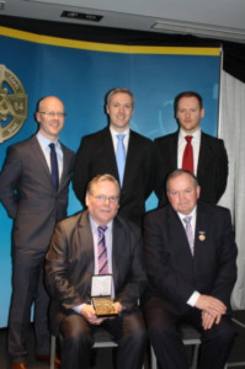 Front row: Club Secretary John Dowd; GAA President Liam O'Neill. Back row: John, Paul and Colm Devaney