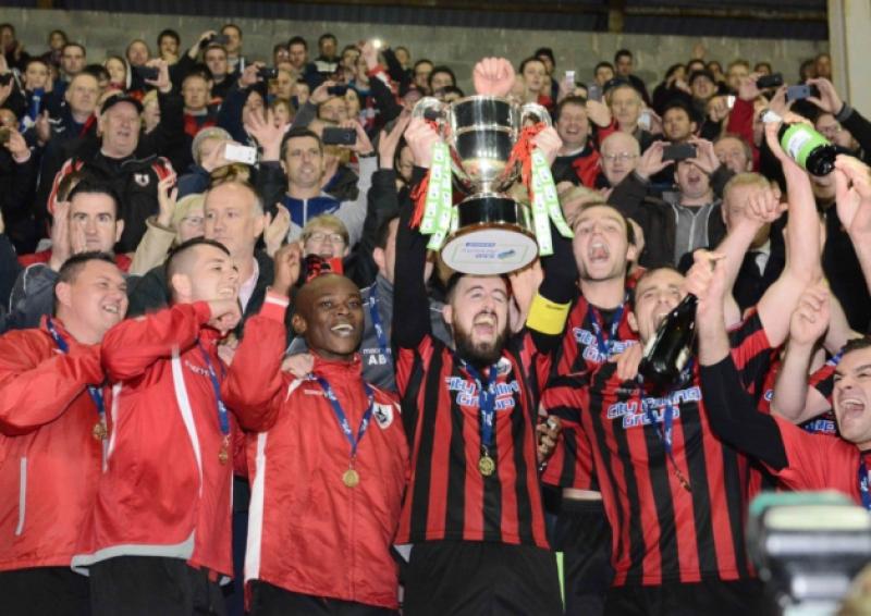 Delighted Longford Town club captain Mark Salmon raises the First Division league trophy amid jubilant scenes at City Calling Stadium on Friday night last. Photo: Declan Gilmore Photography