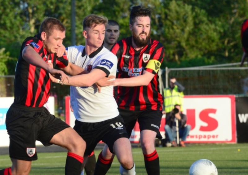 Dundalk player Ronan Finn is crowded out by Longford Town opponents Rhys Gorman (left) and Mark Salmon. Action from the Premier Division league game at Oriel Park on Friday night last. Photo: Ciaran Culligan.
