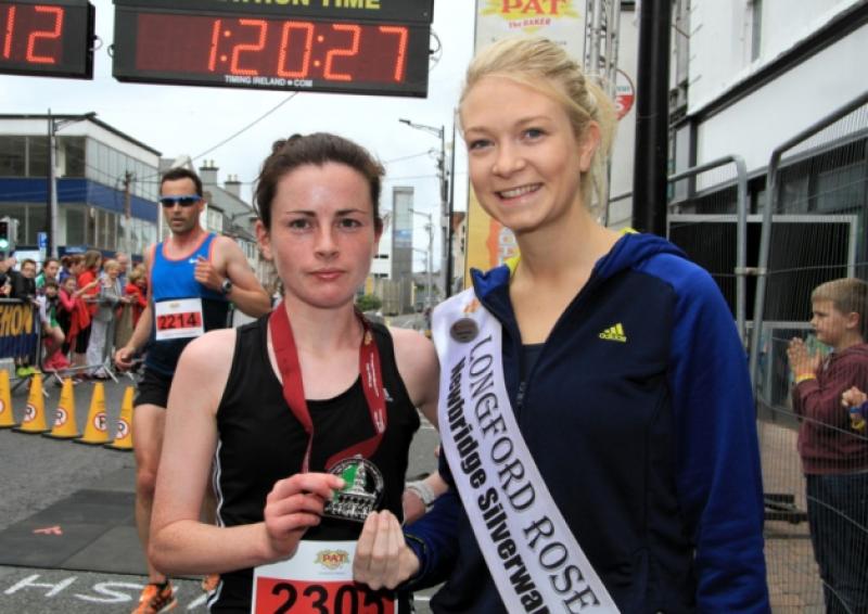 Dromard native Michelle McGee was the first lady to cross the finish line in the half marathon event at the 14th annual Pat the Baker Longford Marathon last Sunday. She is pictured with Longford Rose Daphne Howard. See page 61 for more photographs. Photo: Michelle Ghee. www.gphotos.ie