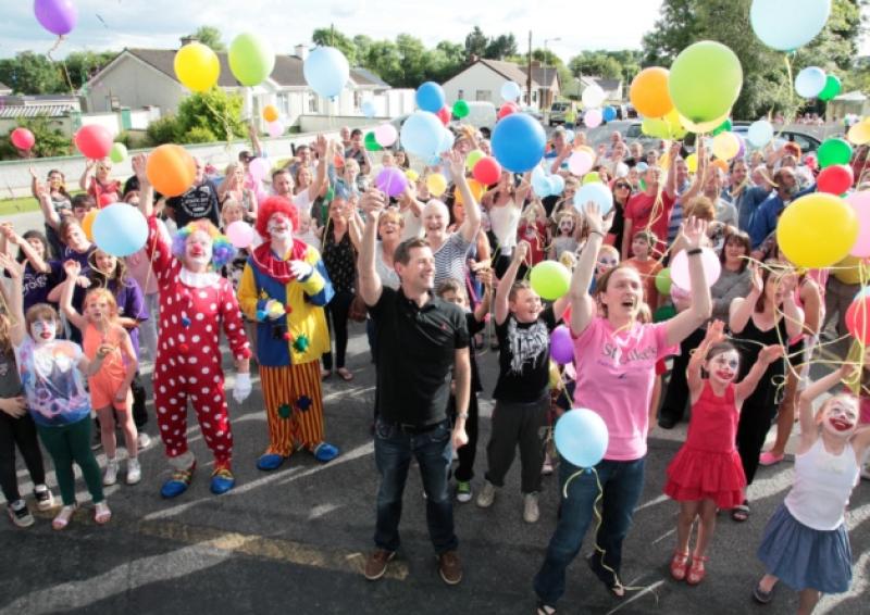 Releasing the balloons in dedication to those who have been lost to or are currently battling against Cancer. Photo By Shelley Corcoran.