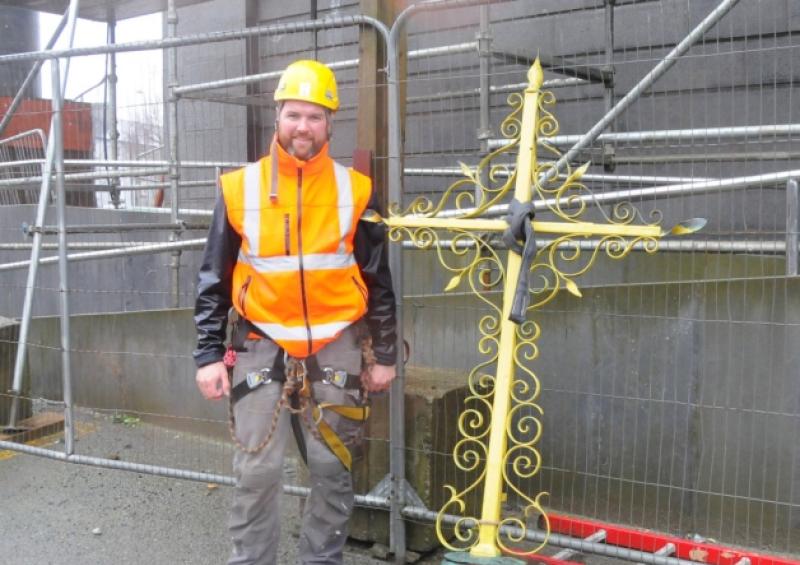 Brian Rainey of Rainey Restoration Ltd with the cross from the spire of St Mel's Cathedral after it was taken down to be cleaned and guilded. Photo: Declan Gilmore