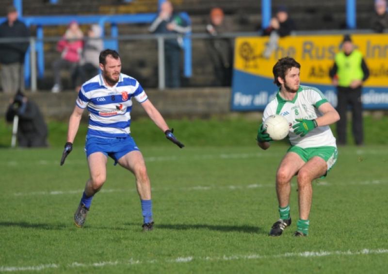 Paddy Thompson on the ball for Killoe Emmet Og ahead of Navan O'Mahonys opponent Cormac McGuinness. Action from the Leinster Club Senior Football Championship quarter-final at Glennon Brothers Pearse Park on Sunday. Photo: Declan Gilmore