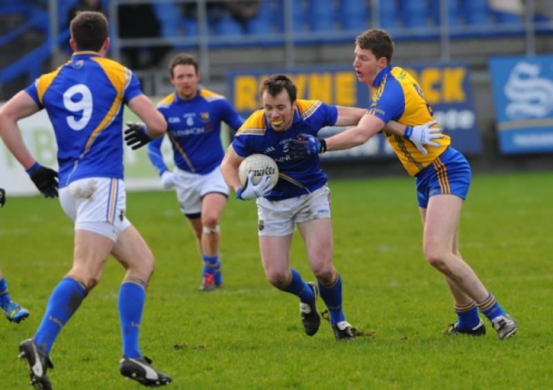 Longford defender Peter Brady evades the challenge of Roscommon midfielder Micheal Finneran. Photo: Kevin Leavy