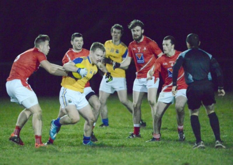 Paddy Kiernan on the ball for Longford in his attempt to evade a cluster of Louth players. The other Longford player in the picture is David McGivney. Action from the Leinster U-21 Football Championship quarter-final in Newtowncashel on Wednesday night of last week. Photo: Declan Gilmore