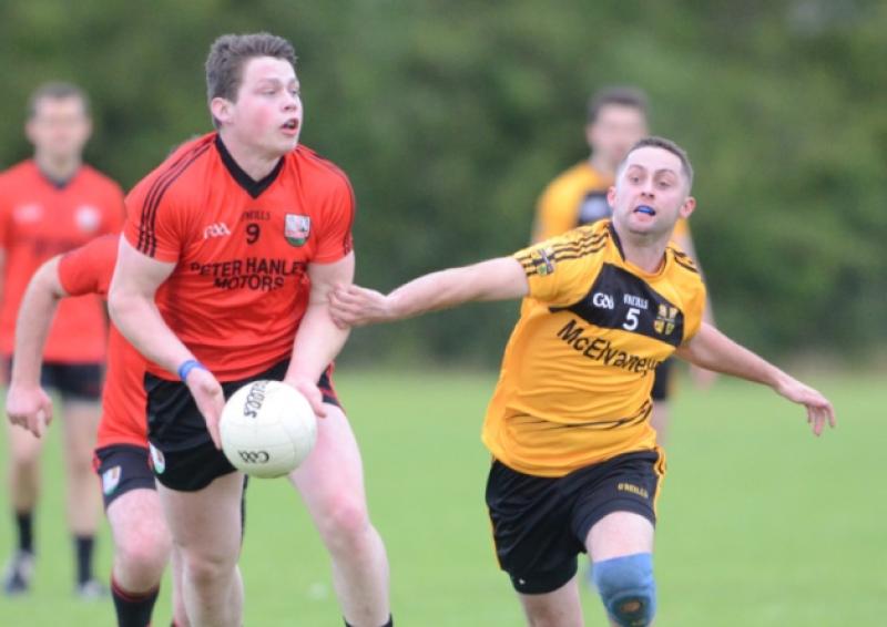 Cashel midfielder Andrew Farrell evading the challenge of Ballymore opponent Kevin Flynn. Photo: Declan Gilmore