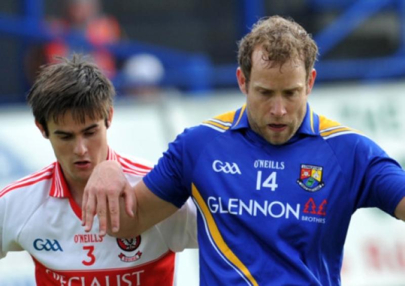Brian Kavanagh is first to the ball for Longford as Derry player Chrissy McKaigue closes in during the first round of the 2012 All Ireland Football Qualifiers.