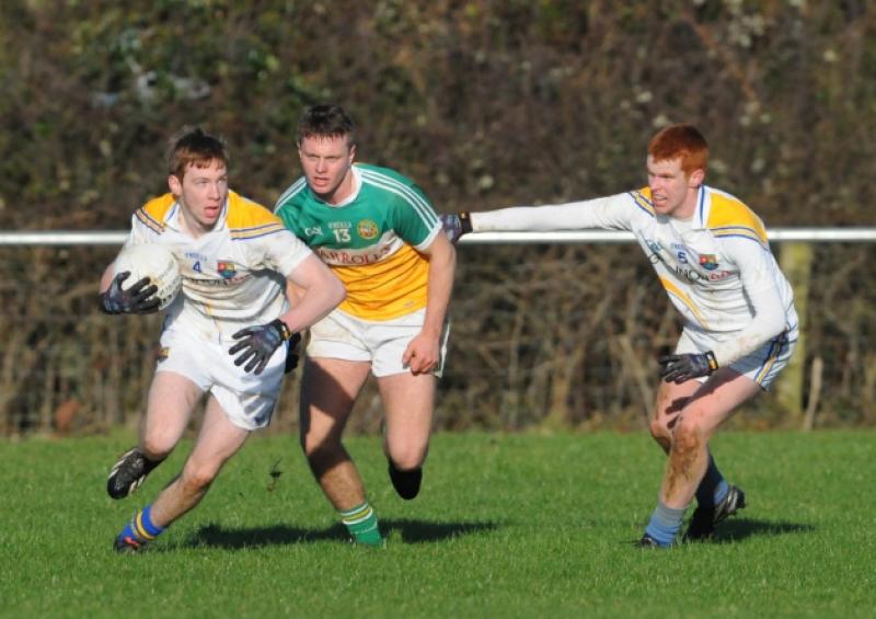 Cian Farrelly coming away with the ball followed by Offaly's Joe Mahe. Photo: Declan Gilmore
