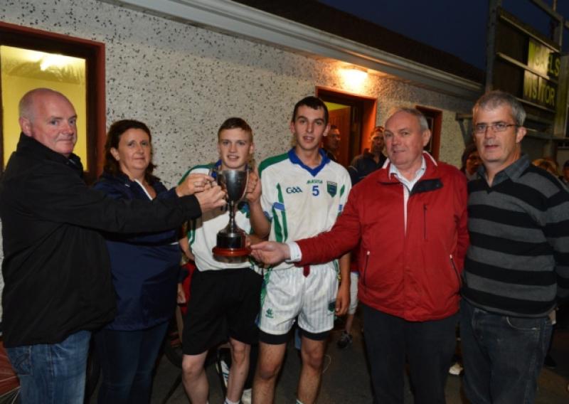 Jimmy and Carmel Brady presents the Glenn Brady Memorial Cup to joint Western Gaels captains Jack Rooney and Paddy Duffy after their victory in the Minor B Football Championship Final on Thursday of last week at McGann Park. Also in the photo sponsor Brian OHara and Minor Chairman Tommy McLoughlin. PHOTO: RAY DONLON