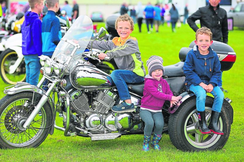 Cillian, Saoirse and Fiachra Fagan looking cool on a motorcycle, which was on display at the recent Vintage Day in Streete Parish Park