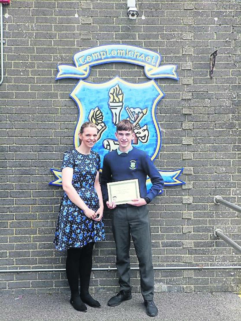 Oisin Killane receiving a Gaeltacht Scholarship Award from Ms Smith