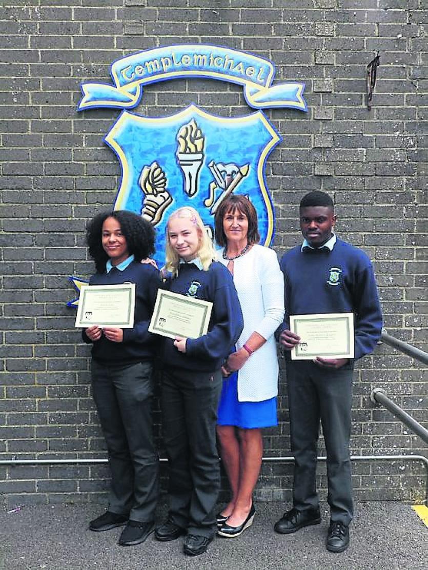 Naomi Togbe, Alekandra Gumiela and Chris Ntotila Maleka receiving European Languages Scholarships from Ms Pyke