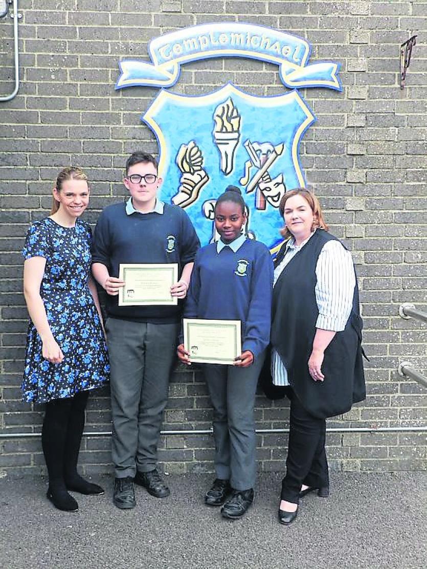Darwin Reilly and Joanna Philips receiving awards for volunteering at St. Christopher's  Lenten Lunch from Ms Smith and Ms NicDhonnacha