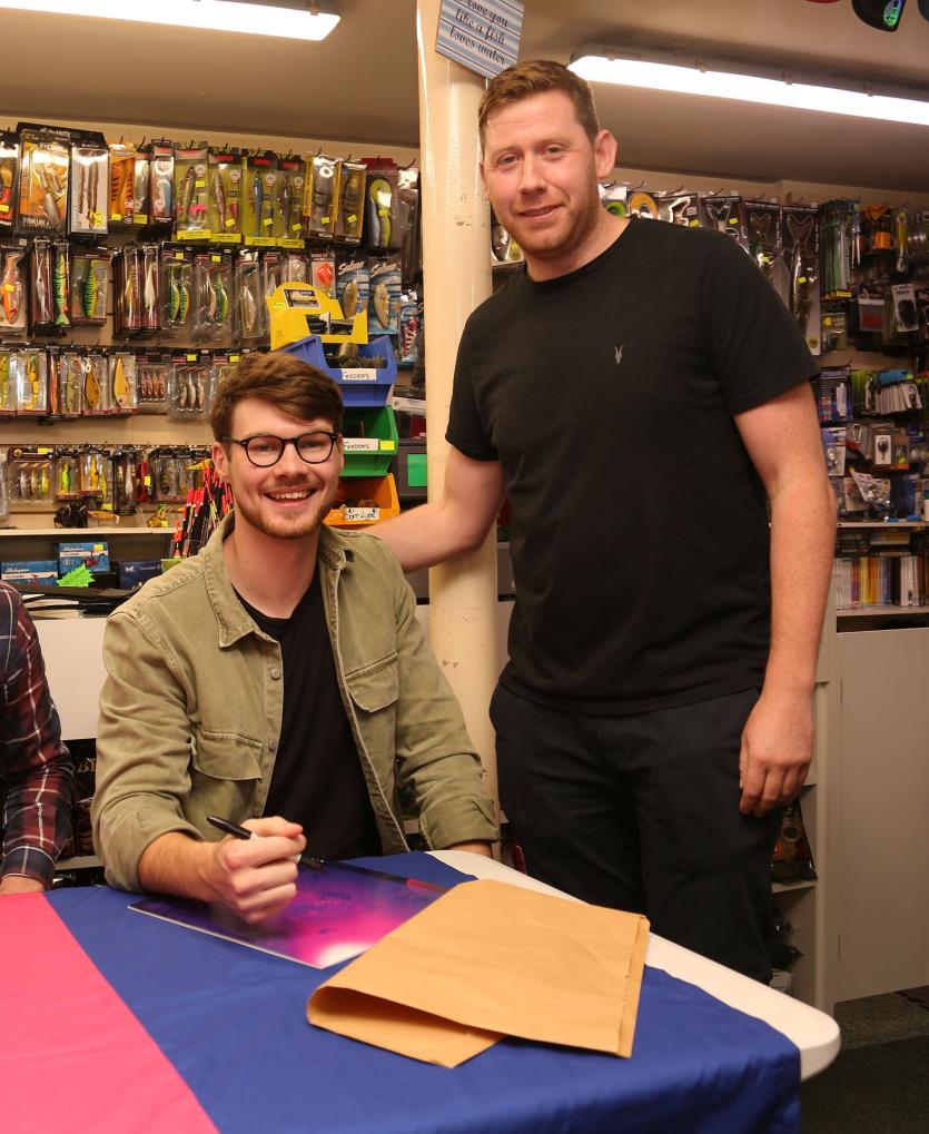 Justin Quinn gets his album signed by Mark Prunty of Brave Giant