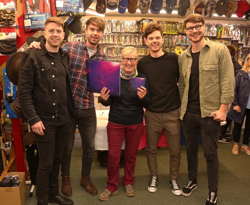 Smiles all round: Denise Denniston with Brave Giant at Denniston's music store in Longford