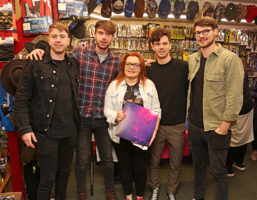 Melissa Slevin with the Brave Giant lads at Denniston's Music shop in Longford on Saturday last