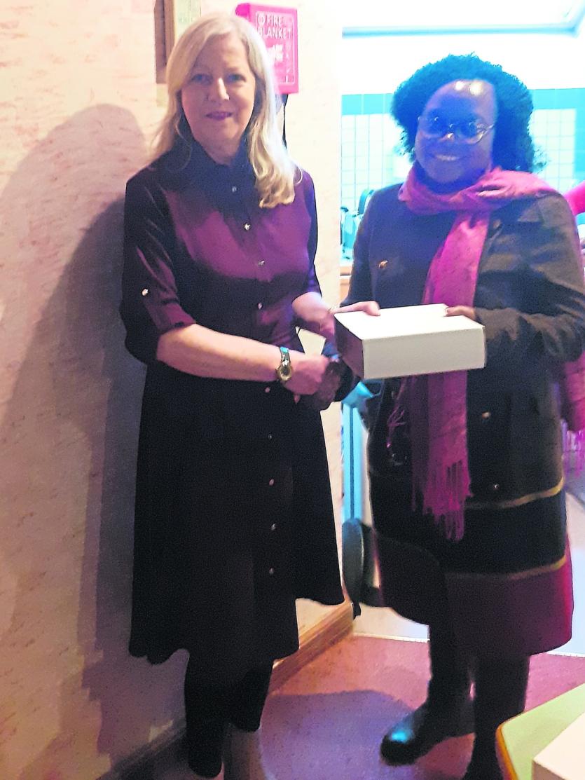 Helen Whitney, Manager, presenting Gladys Lusweti, KUSSCO, with a gift to mark their visit to Longford Credit Union