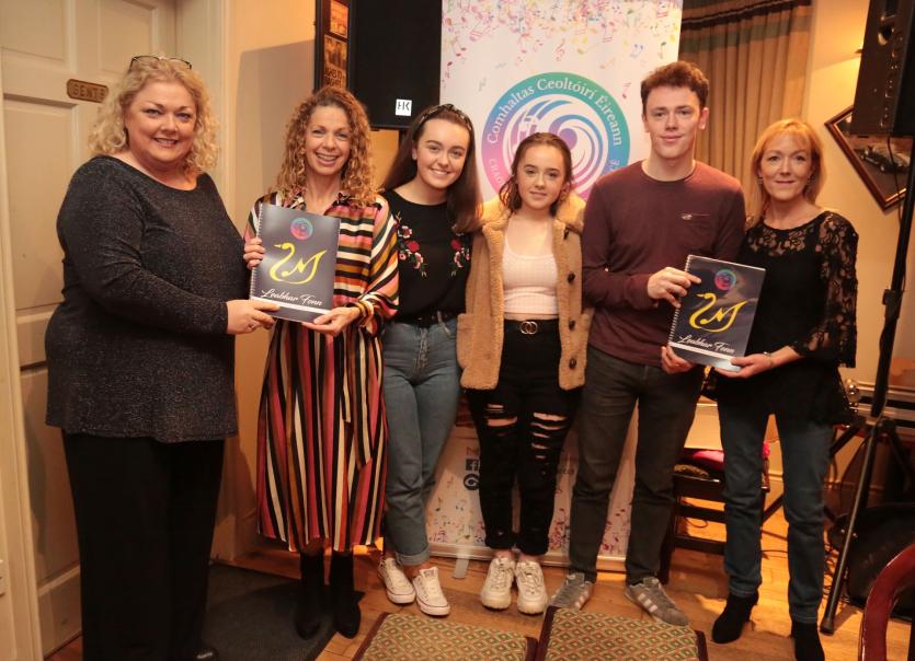 Yvonne Ni Mhurchu presenting book to Collette Meally,  Molly and Alaidh Ni Mhuiri, Daire Ó Muirí and Áine O'Sullivan