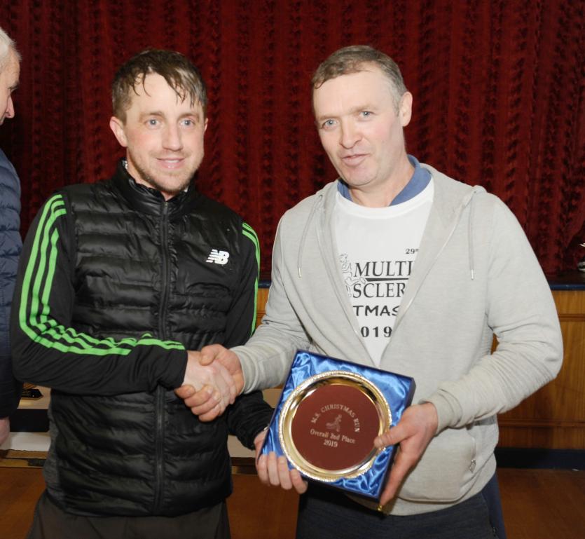 Matthew Thompson presents 2nd place trophy to Declan Newman at the Christmas Day Run  PICTURE DECLAN GILMORE