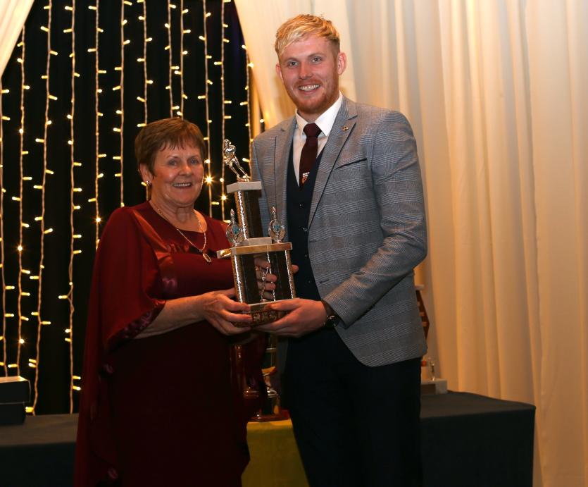 Fr Manning Gaels dinner dance 23.     Eileen Kerrigan presents Paddy Collum with the senior player of the year award.             Picture: Syl Healy