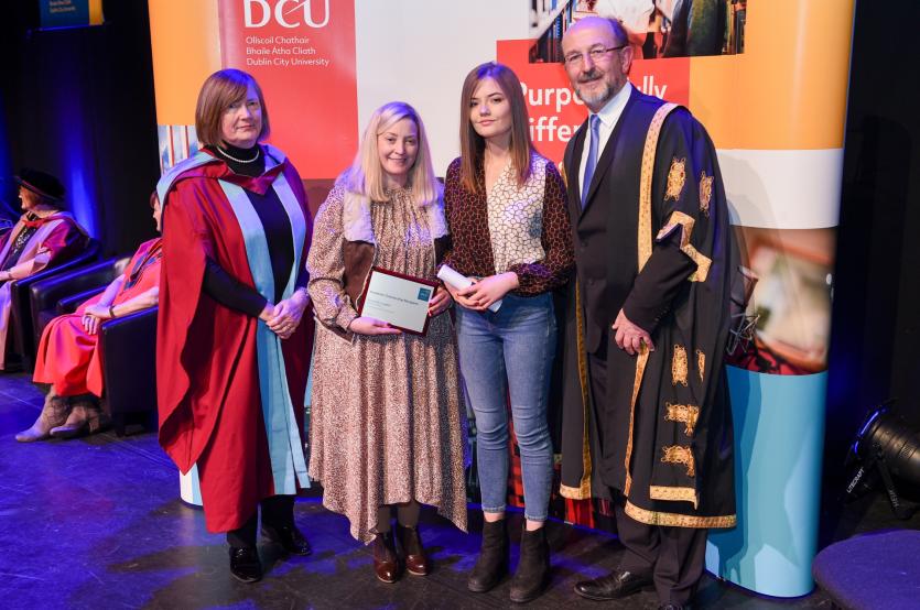 Olivia McLoughlin pictured receiving her award with Professor Brian MacCraith, Margarita Fallon and Professor Michelle Butler